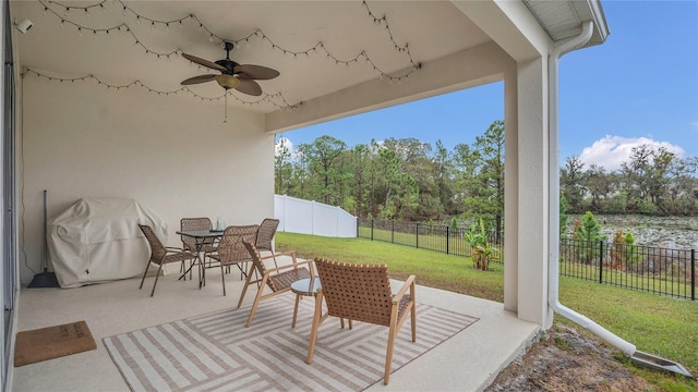 view of patio / terrace featuring outdoor dining space, a ceiling fan, a fenced backyard, and a grill