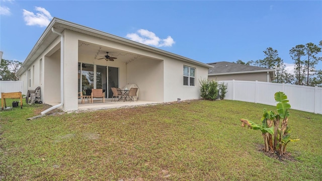 rear view of house featuring a patio area, a fenced backyard, stucco siding, and ceiling fan
