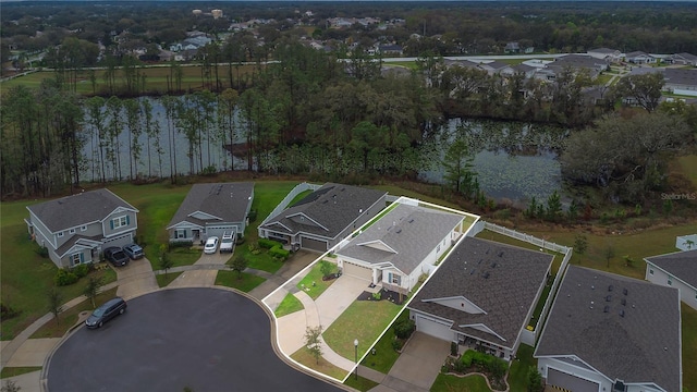 drone / aerial view featuring a residential view and a water view