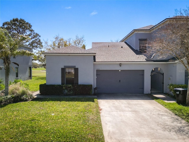 view of front facade featuring a gate, an attached garage, stucco siding, a front lawn, and concrete driveway