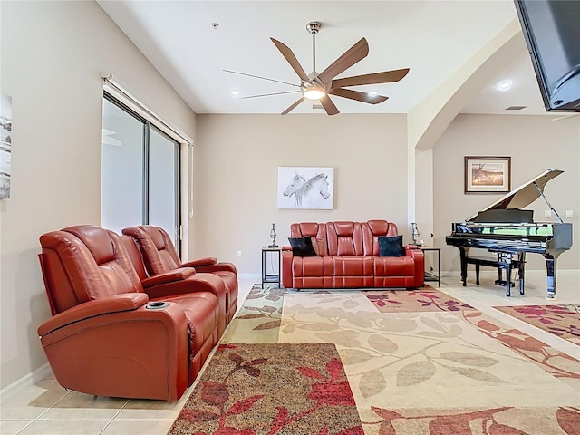 living area featuring visible vents, recessed lighting, arched walkways, light tile patterned flooring, and baseboards