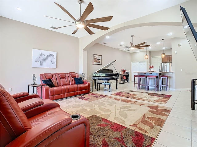 living area featuring visible vents, a ceiling fan, recessed lighting, arched walkways, and light tile patterned flooring