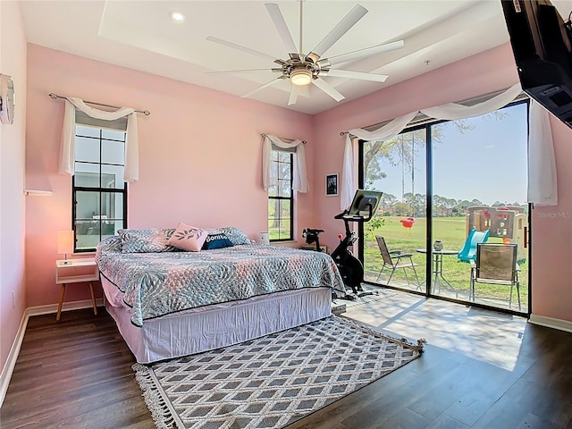 bedroom featuring wood finished floors, baseboards, recessed lighting, ceiling fan, and access to outside