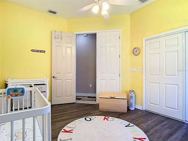 bedroom with visible vents, baseboards, and dark wood-style floors