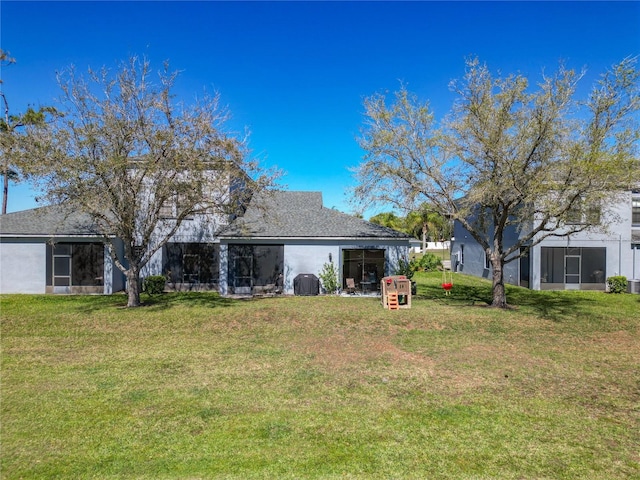 rear view of house featuring a lawn