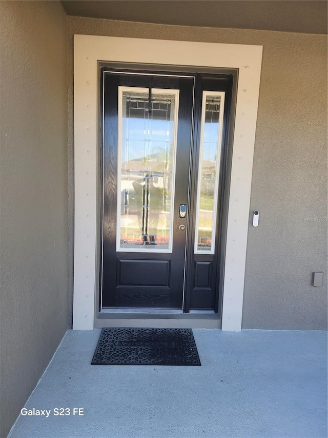 doorway to property with stucco siding