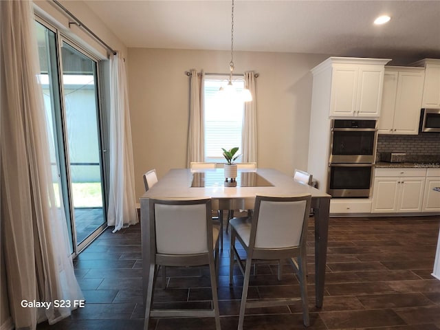 dining area featuring wood finish floors and recessed lighting