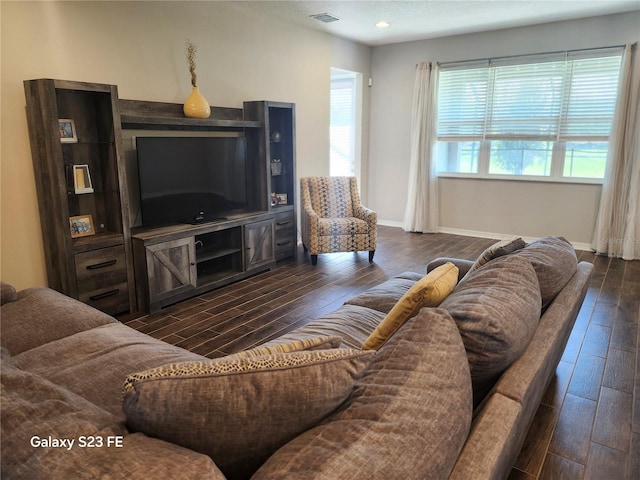 living room with dark wood finished floors, recessed lighting, visible vents, a textured ceiling, and baseboards