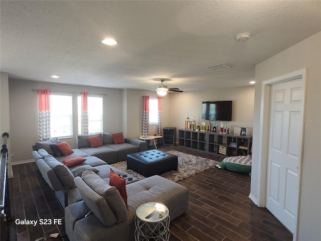 living room featuring a textured ceiling, ceiling fan, recessed lighting, and wood tiled floor