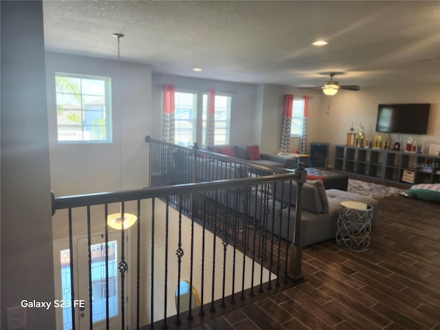 living room with wood finish floors, plenty of natural light, a textured ceiling, and recessed lighting