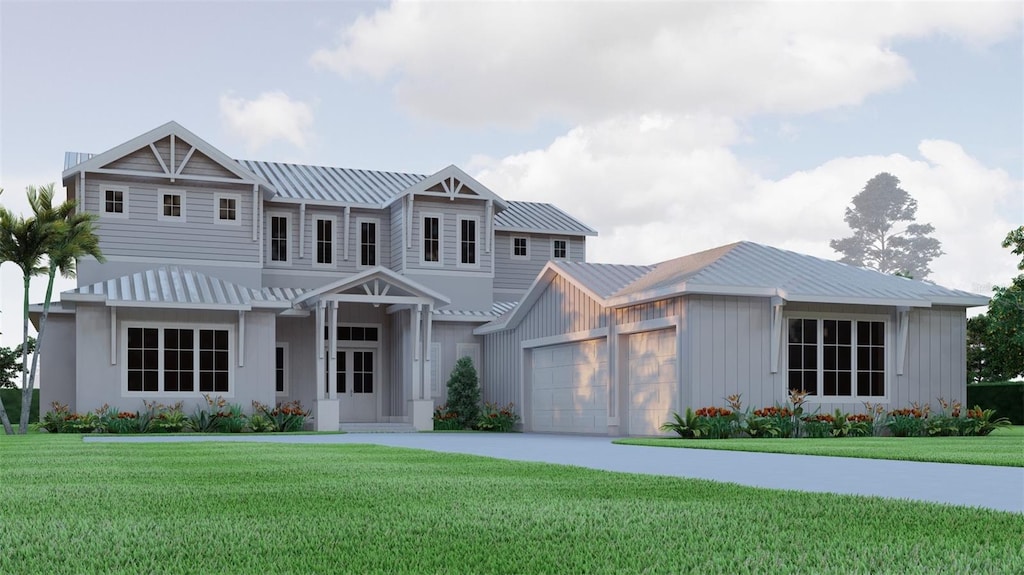 view of front of house with a front yard, a standing seam roof, concrete driveway, a garage, and metal roof