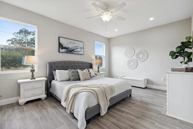 bedroom featuring wood tiled floor, baseboards, a ceiling fan, and recessed lighting