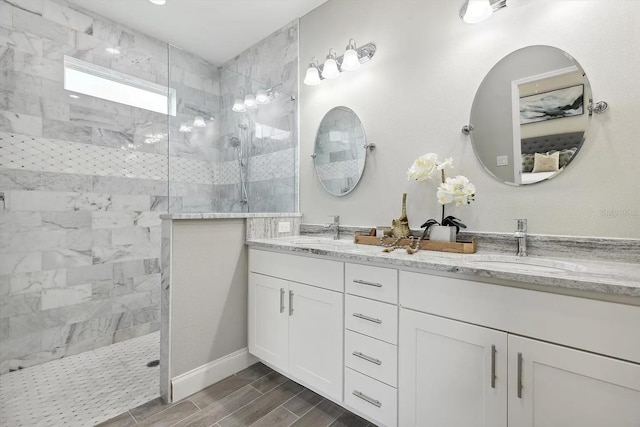 full bath with wood tiled floor, a sink, and walk in shower