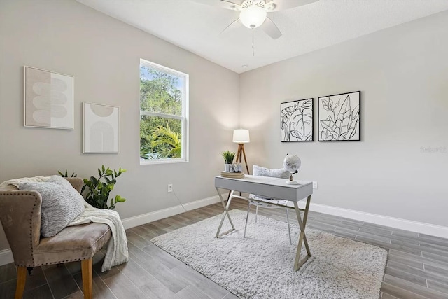 office area featuring ceiling fan, baseboards, and wood finished floors