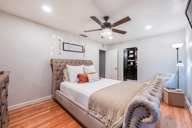 bedroom featuring light wood finished floors, recessed lighting, visible vents, a ceiling fan, and baseboards