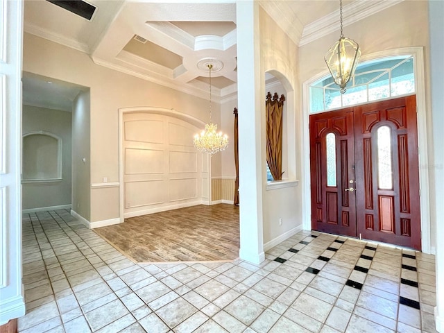 foyer featuring a chandelier, ornamental molding, and light tile patterned floors