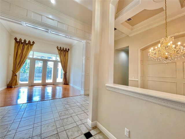 interior space featuring french doors, crown molding, visible vents, an inviting chandelier, and baseboards