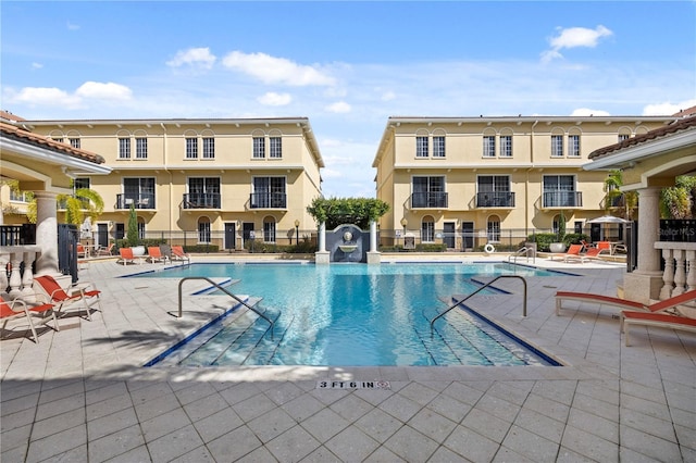 pool featuring a patio and fence