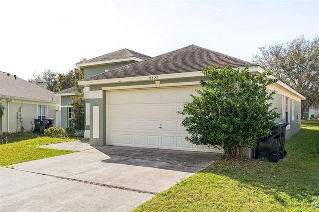 exterior space with stucco siding, a lawn, driveway, a shingled roof, and a garage