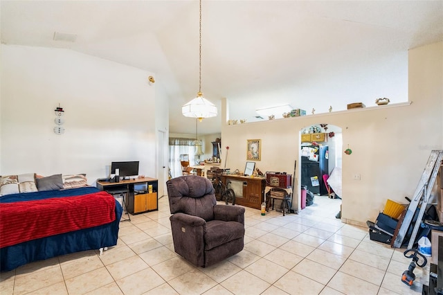 bedroom with vaulted ceiling and light tile patterned floors