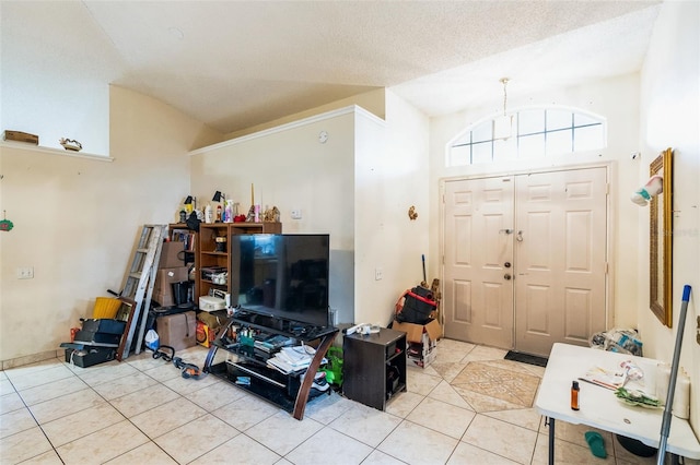 living area featuring lofted ceiling, light tile patterned floors, and a textured ceiling