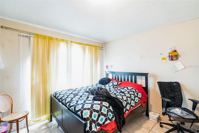 tiled bedroom featuring a textured ceiling