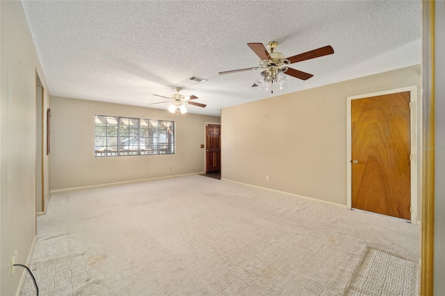 unfurnished room featuring visible vents, baseboards, a textured ceiling, and carpet flooring