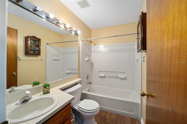 full bath featuring wood finished floors, visible vents, a textured ceiling, shower / tub combination, and toilet