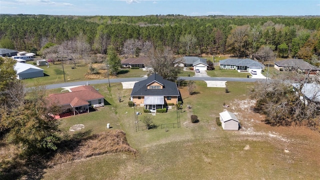 birds eye view of property featuring a residential view and a wooded view