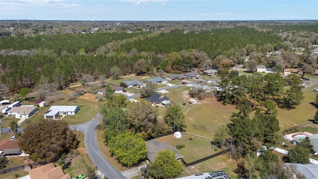 birds eye view of property with a forest view and a residential view