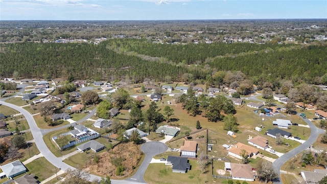 birds eye view of property with a wooded view and a residential view