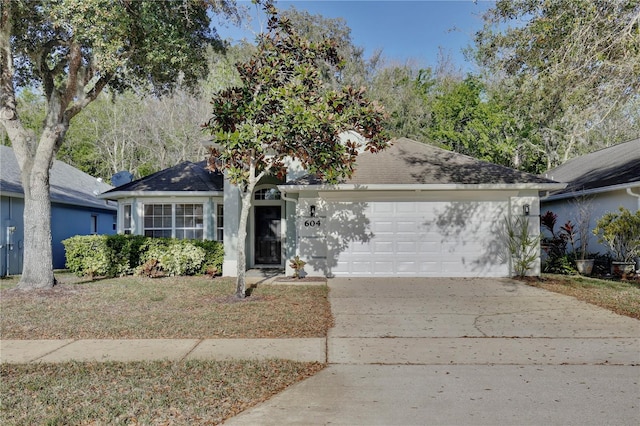 ranch-style home featuring concrete driveway and an attached garage