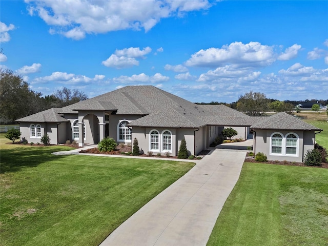 view of front facade featuring concrete driveway, a front lawn, and stucco siding