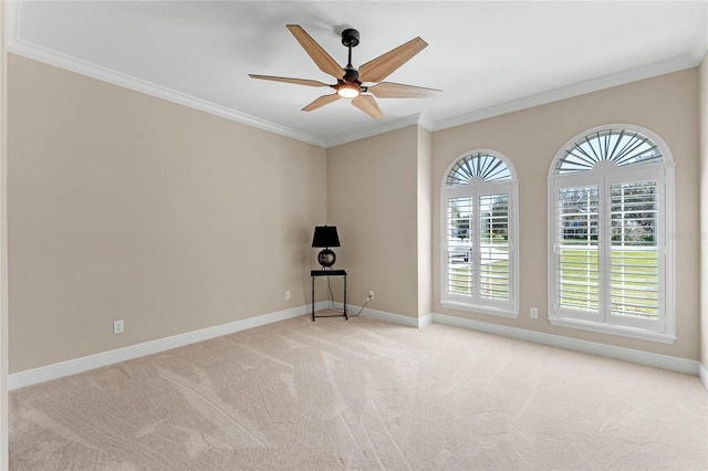 unfurnished room with ornamental molding, light colored carpet, baseboards, and a ceiling fan