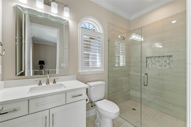 bathroom with toilet, vanity, baseboards, a shower stall, and crown molding