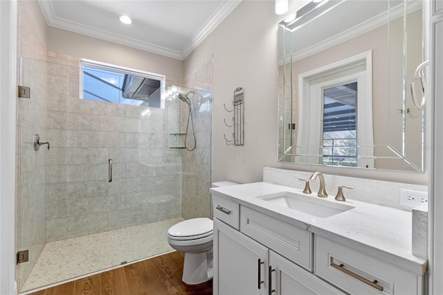 full bathroom with toilet, crown molding, wood finished floors, and a shower stall