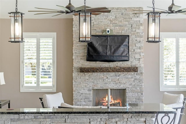 living room with a fireplace and ceiling fan