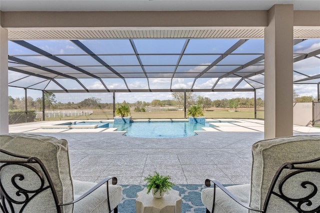 view of pool with a lanai, a patio area, and a pool with connected hot tub