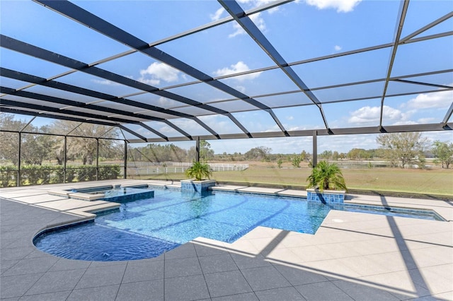 view of pool with a patio, a lanai, and a pool with connected hot tub