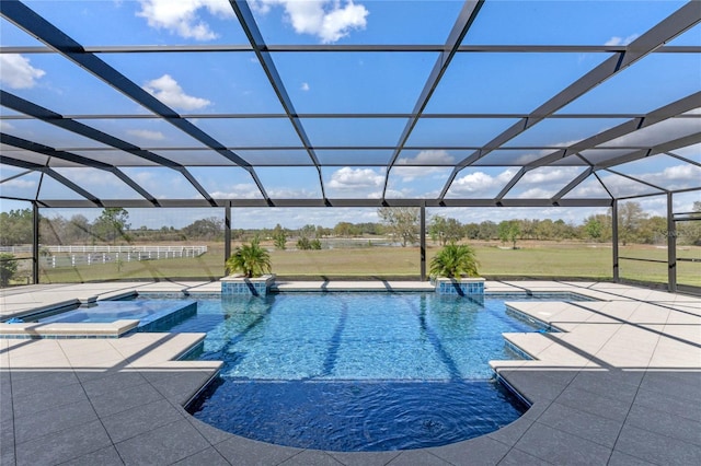 view of swimming pool featuring a pool with connected hot tub, a lanai, a patio, and a lawn