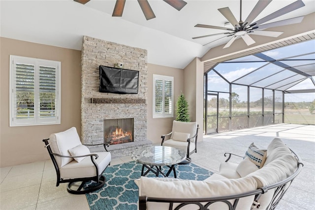 view of patio with glass enclosure, an outdoor living space with a fireplace, and a ceiling fan