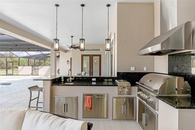 view of patio / terrace with exterior kitchen, glass enclosure, a grill, and a sink