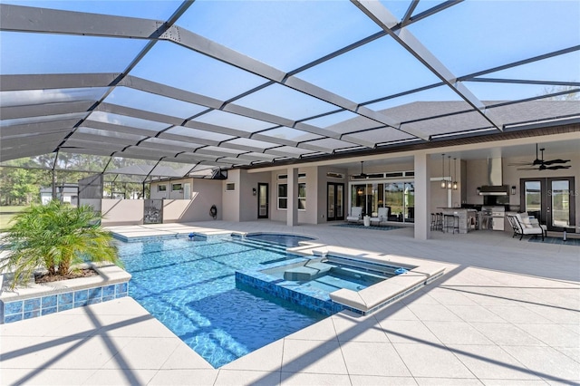 view of pool featuring ceiling fan, a pool with connected hot tub, outdoor dry bar, french doors, and a patio area