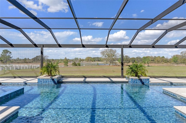 outdoor pool with a patio, a lawn, and a lanai