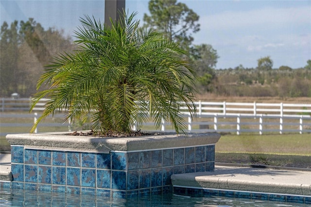 exterior details featuring fence and a pool