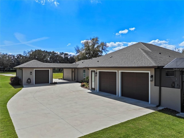 single story home with an attached garage, a shingled roof, concrete driveway, stucco siding, and a front yard