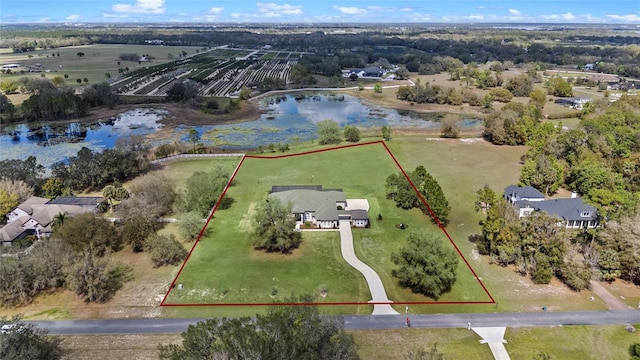 birds eye view of property featuring a water view and a rural view