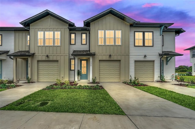 multi unit property featuring board and batten siding, concrete driveway, and a garage