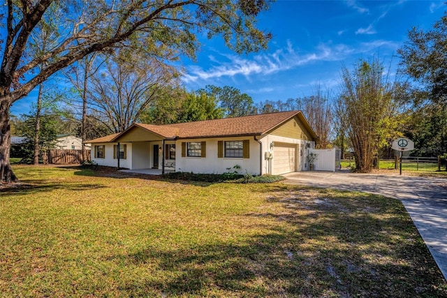 ranch-style house featuring a garage, driveway, fence, and a front lawn