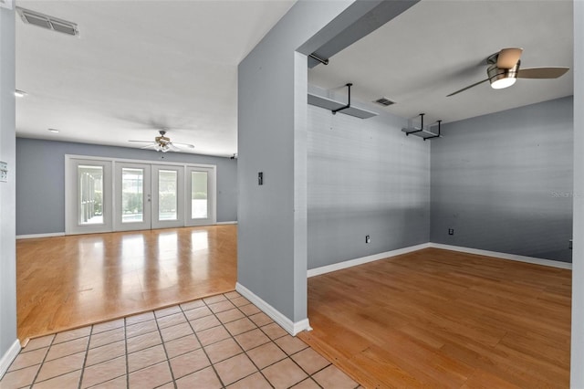 empty room with a ceiling fan, visible vents, and light wood-style floors